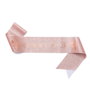 Detail view of Mommy To Be rose gold glitter sash with elegant foil lettering for baby showers