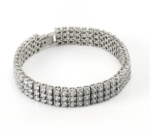 Macro view showing the triple-row diamond setting and clasp on the steel tennis bracelet