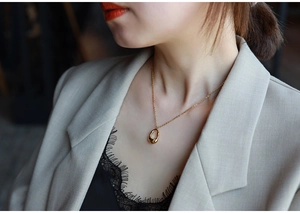 Close-up of minimalist gold teardrop necklace worn on model for an elegant style