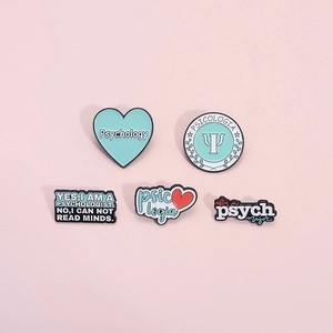 Psychology themed enamel pins set with heart shapes and Greek Psi letter on pink background