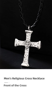 Detail of silver bolo tie cross pendant with hammered texture and heart inlay on black cord