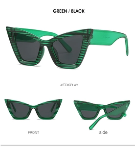 Detail view of cat eye sunglasses featuring green and black zebra stripes and dark lenses
