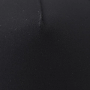 Macro detail of high-quality black fabric texture and fine stitching on the baseball cap