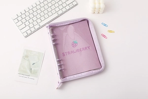 Detail of purple glitter PVC binder with strawberry design and secure zipper closure