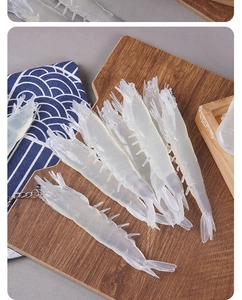 Detailed view of realistic transparent PVC shrimp keychain with lifelike texture on wood