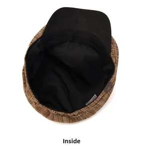 Detail view of the brown striped newsboy hat with black lining and metal button detail