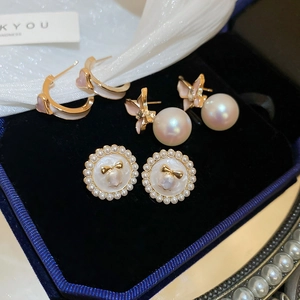 Vue détaillée de trois paires de boucles d'oreilles vintage en émail rose et perles