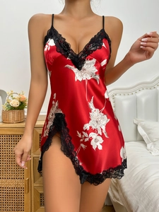 Close-up of red silk floral nightdress featuring black lace trim and delicate straps