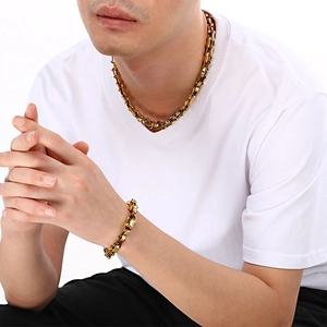 Close-up of gold stainless steel bamboo chain necklace and bracelet set on a model