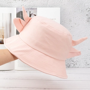 Detailed view of a pink cotton bucket hat featuring cute small horns for children