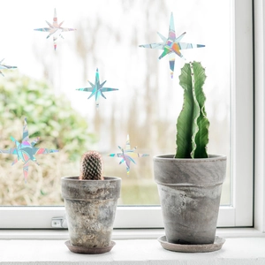 Rainbow prism window stickers with holographic star patterns applied on glass surface