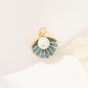 14K gold shell pendant with light blue enamel and a white pearl on white fabric