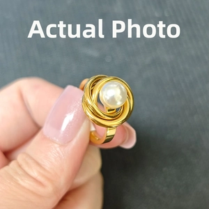 Detailed close-up of a golden layered pearl ring showcasing the white pearl inlay
