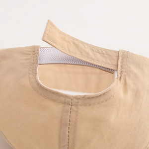 Detail of adjustable Velcro strap on beige quick-dry sun hat for toddlers