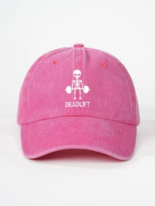 Detailed view of the DEADLIFT skull print on a washed rose pink cotton baseball cap