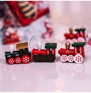 Detailed view of hand-painted wooden Christmas train ornaments with gold hanging strings