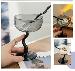 Macro shot of grey tinted glass dessert cup with twisted black stem and matching spoon