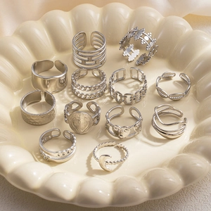 Detailed macro shot of vintage silver rings with layered, moon, and heart-shaped elements