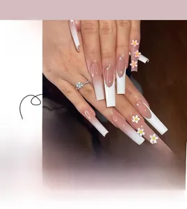 Detail of French ombre press-on nails with 3D embossed flowers and pearl accents