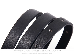 Close-up of black leather belt detail featuring natural lychee texture and round holes