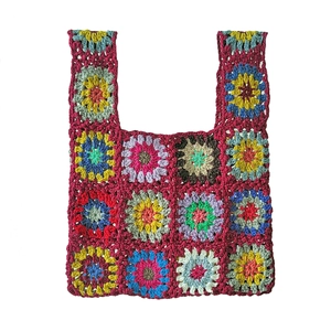 Detailed close-up of handmade granny square crochet tote bag with colorful patchwork pattern