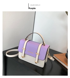 Detailed view of a purple and white leather crossbody bag with metal buckle and strap