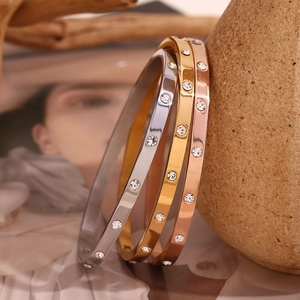 Macro shot of 18K gold plated stainless steel bangles with sparkling zircon stone inlay