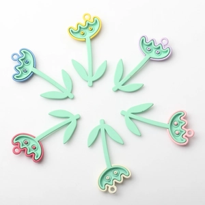 Macro shot of colorful tulip charms for DIY jewelry making in various pastel floral colors