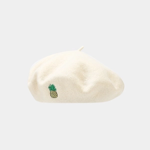 Detailed view of cream wool beret featuring a fine pineapple embroidery and soft texture