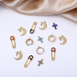 Detailed view of gold stainless steel DIY pendants with colorful rhinestones and moon shapes