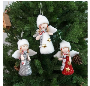 Plush Christmas angel dolls with knit hats and star charms hanging on a festive tree branch