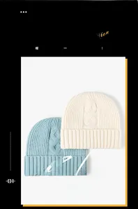 Detail showing cable knit texture and fold-over cuff on cream and blue winter beanies
