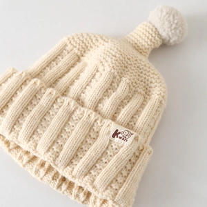 Cream knit beanie with pompom and patch, stylish warm winter hat for kids