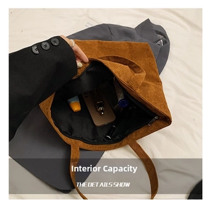 Detail view of large corduroy tote bag showing spacious interior with zipper pocket