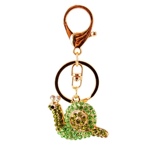Cute snail keychain with green rhinestones and golden metal hardware on white background