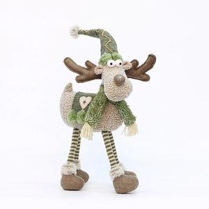Plush Christmas reindeer ornament with green scarf and tall hat on white background