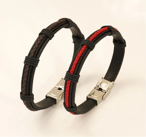 Detail of men's leather bracelets showing stainless steel clasps and woven texture