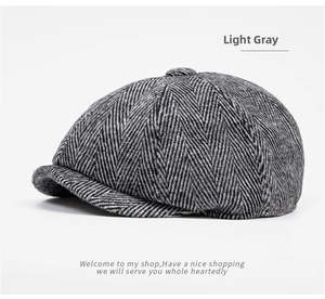 Detailed view of light gray newsboy cap featuring classic herringbone wool fabric