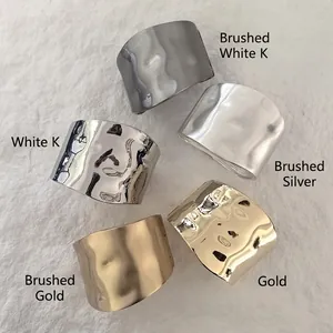 Irregular textured wide cuff bracelets in gold and silver finishes with brushed surface