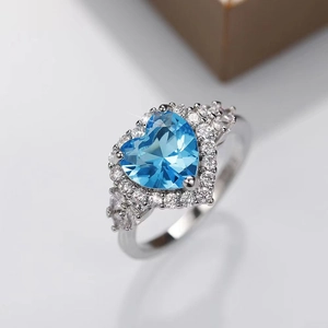 Topaz blue heart-shaped gemstone ring with micro-paved small zircons in silver finish