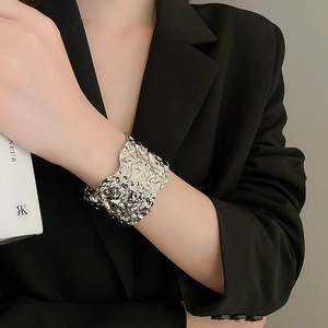 Silver geometric textured wide cuff bracelet with a unique irregular lava-like molten design