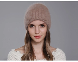 Detail of soft winter angora rabbit fur beanie with thick ribbed knit cuff on a model