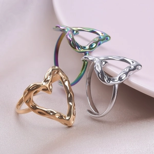 Detailed close-up of adjustable heart rings in gold, silver, and colorful hammer texture finish