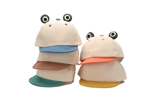 Detail of colorful frog baseball caps showing 3D eye decor and contrast brims