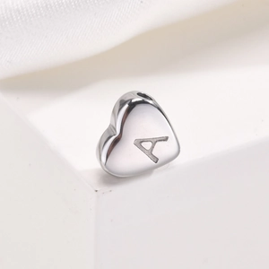 Detailed macro view of heart-shaped stainless steel pendant with engraved letter A