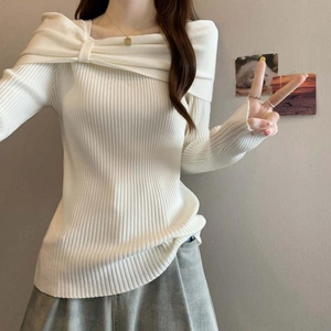 Detail of white slim fit ribbed knit sweater featuring an asymmetric bow collar design