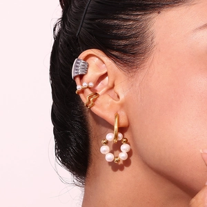 Detailed view of 18K gold plated U-shaped earrings with freshwater pearls on female ear