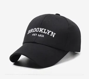 Side view of black cotton baseball cap featuring white Brooklyn EST 1631 embroidery