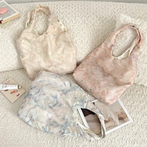 Close-up of lace tote bags with bow embroidery and macaron ombre lining detail