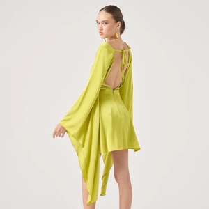 Detail of lime green satin backless dress showing elegant lace-up waist and draped fabric